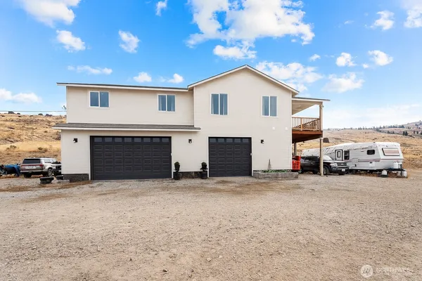a view of a house with a yard and garage