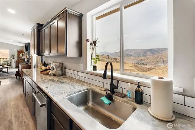 a kitchen with a sink and a large window