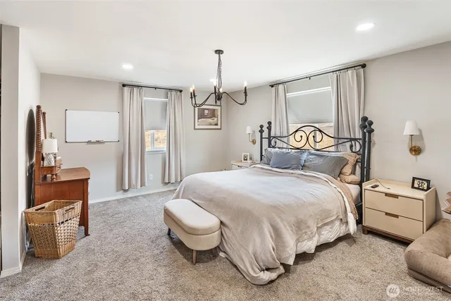 a bedroom with a bed and a chandelier