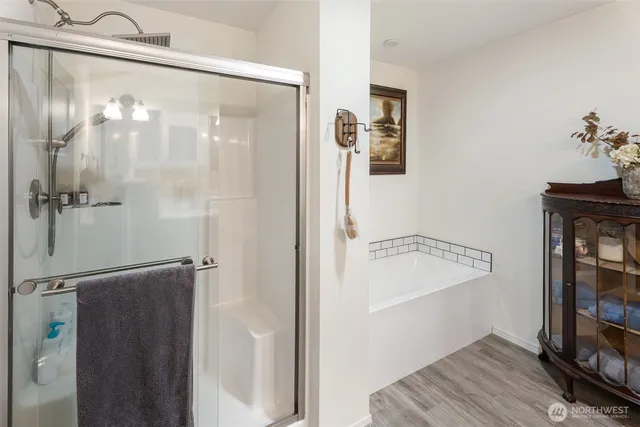 a bathroom with a shower and a bath tub