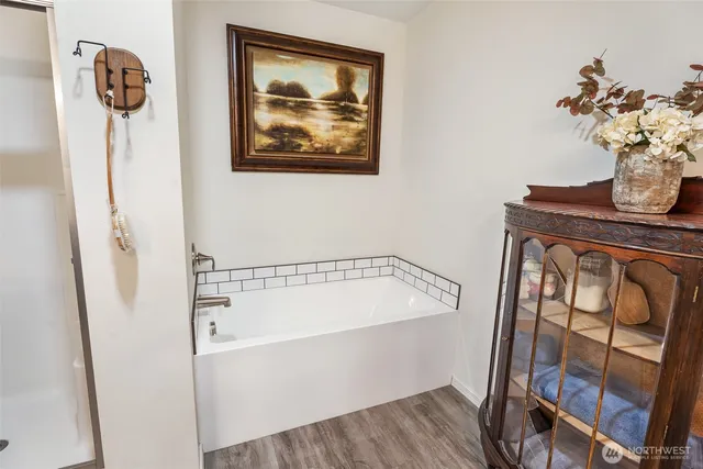 a bathroom with a bathtub and a shower