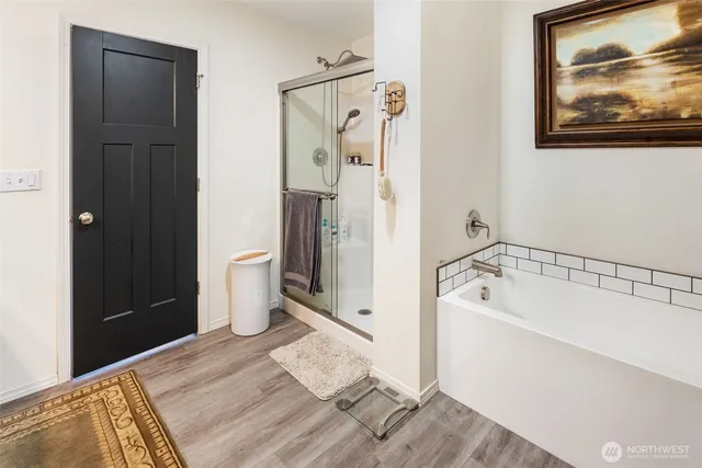 a bathroom with a tub sink and shower