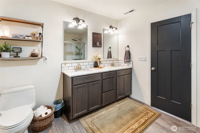 a bathroom with a sink toilet and shower