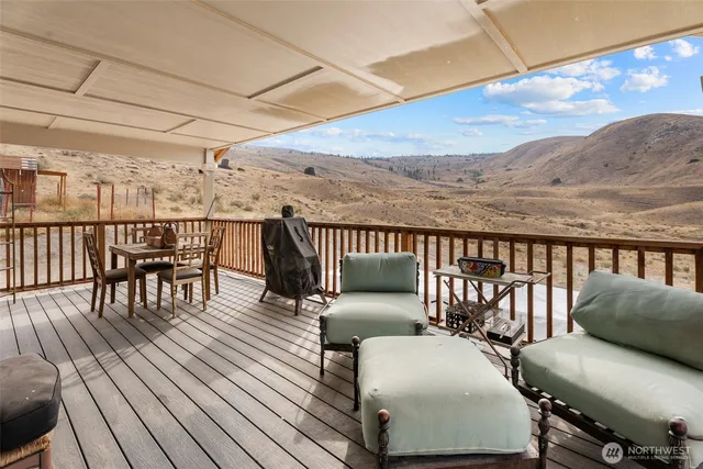 a balcony with wooden floor outdoor seating and wooden floor