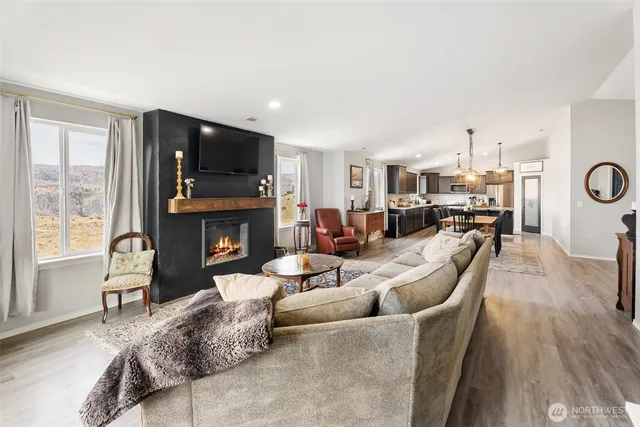 a living room with furniture fireplace and flat screen tv
