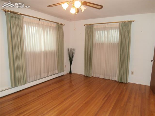 1642 Fuller Road Colorado Springs, CO 80920 - Photo 6 of 22 Spacious Master with lovely wood floors, walk in closet, and adjoining 3/4 bath