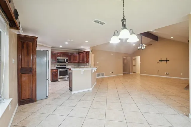 a view of a kitchen with cabinets and stainless steel appliances