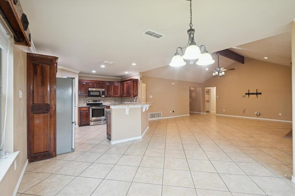 548 Highland Road Springtown, TX 76082 - Photo 13 of 40 a view of a kitchen with cabinets and stainless steel appliances
