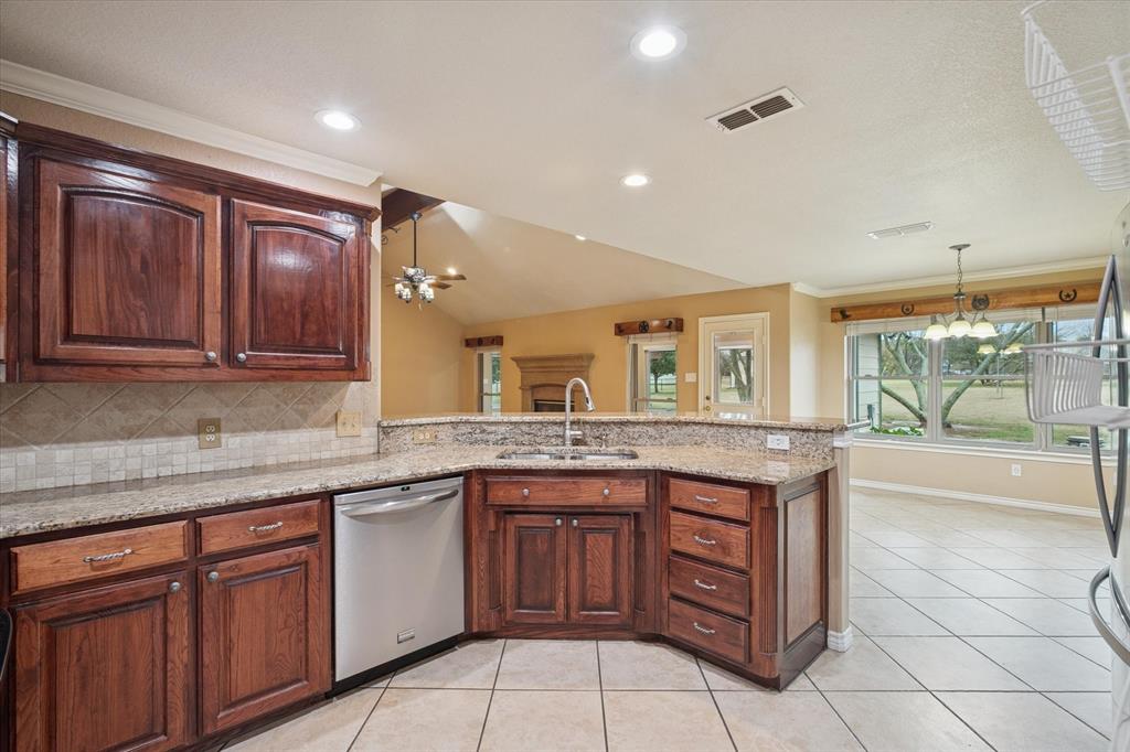 548 Highland Road Springtown, TX 76082 - Photo 16 of 40 a kitchen with a sink and cabinets
