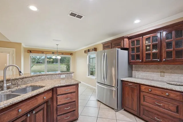 a kitchen with stainless steel appliances granite countertop a refrigerator and a sink