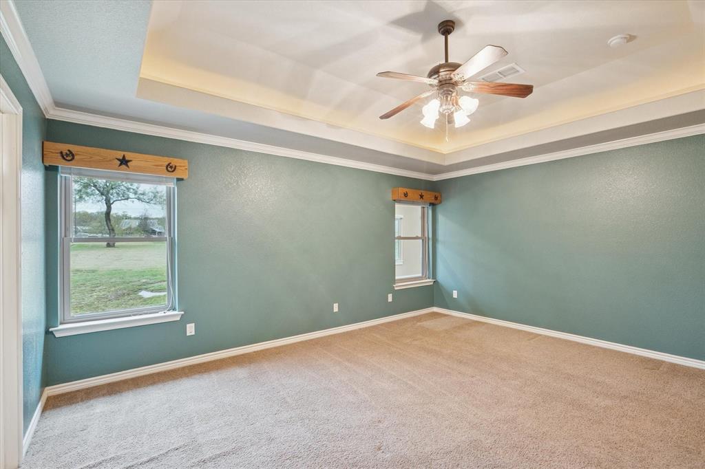 548 Highland Road Springtown, TX 76082 - Photo 19 of 40 an empty room with a window and a fan
