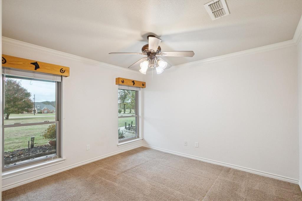 548 Highland Road Springtown, TX 76082 - Photo 24 of 40 an empty room with windows and entrance
