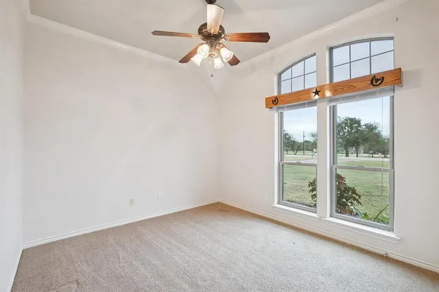 a view of a livingroom with a ceiling fan and window