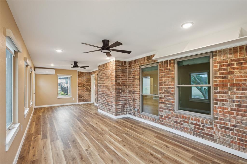 548 Highland Road Springtown, TX 76082 - Photo 33 of 40 a view of a livingroom with wooden floor and a ceiling fan