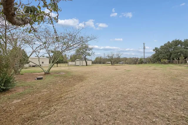 a view of a field with trees