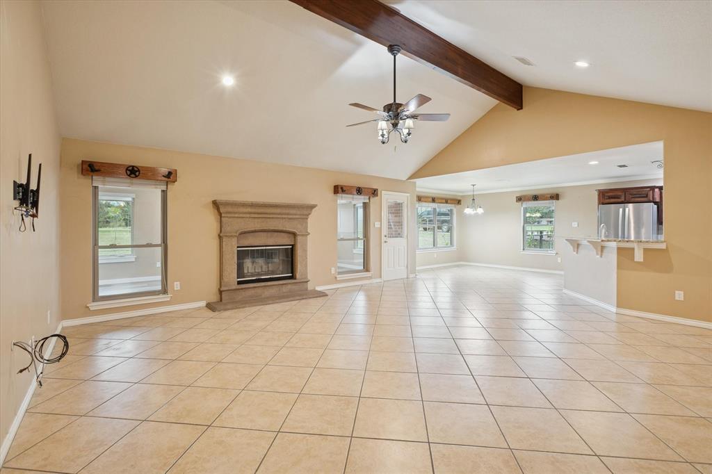 548 Highland Road Springtown, TX 76082 - Photo 6 of 40 a view of an empty room with a fireplace and a window