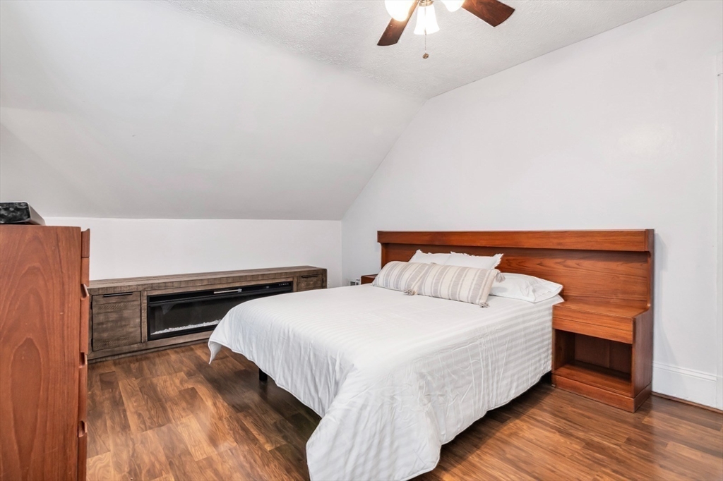 42 D Street Lowell, MA 01851 - Photo 23 of 27 a bedroom with a bed and a ceiling fan