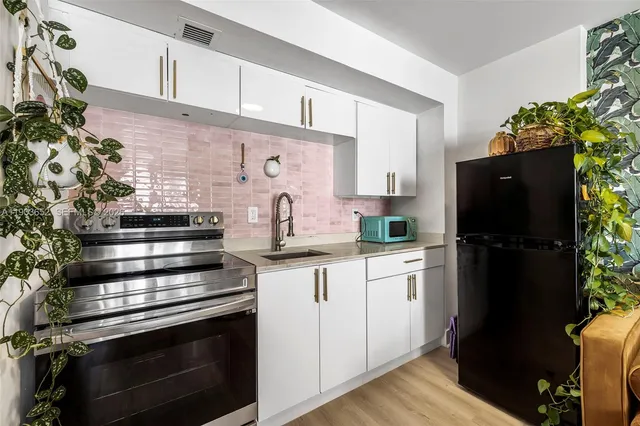 a kitchen with appliances and cabinets