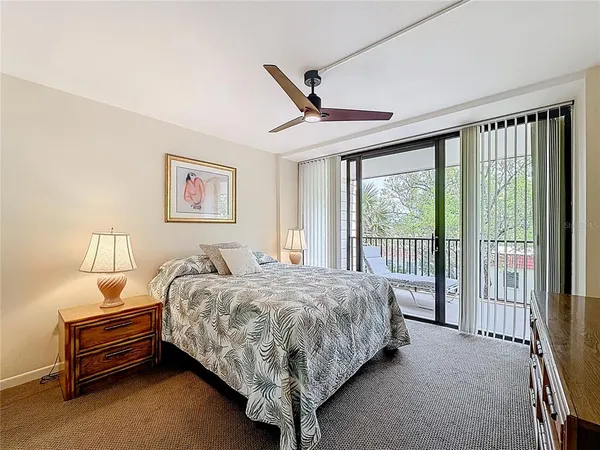 a bedroom with bed and a chandelier