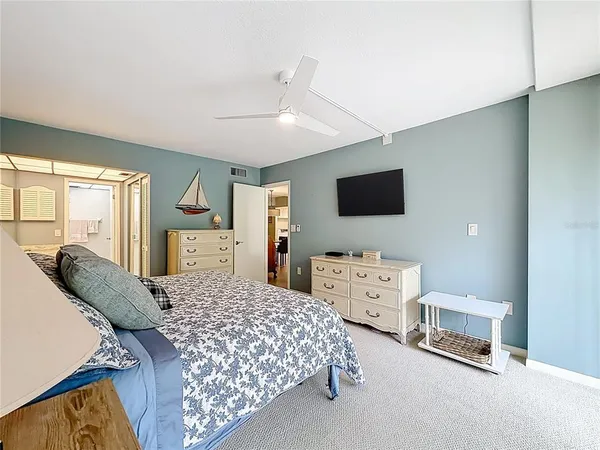 a bedroom with a bed dresser and a window