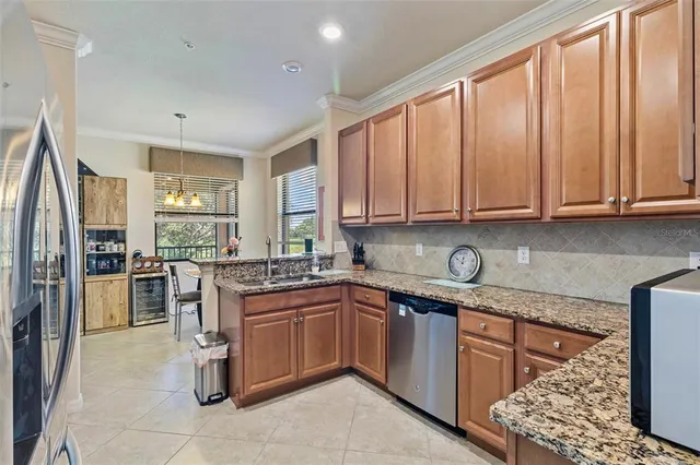 a kitchen with granite countertop a refrigerator and a sink