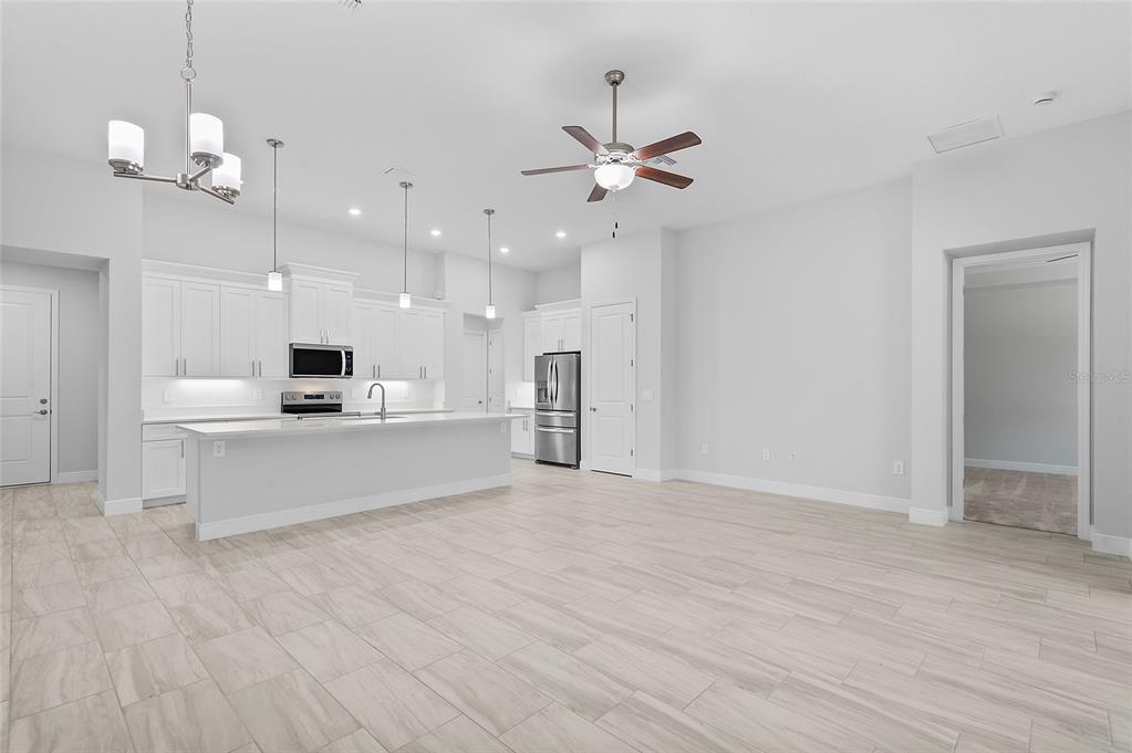 304 North Jungle Road Geneva, FL 32732 - Photo 17 of 49 a view of kitchen with kitchen island stainless steel appliances refrigerator stove and wooden floor