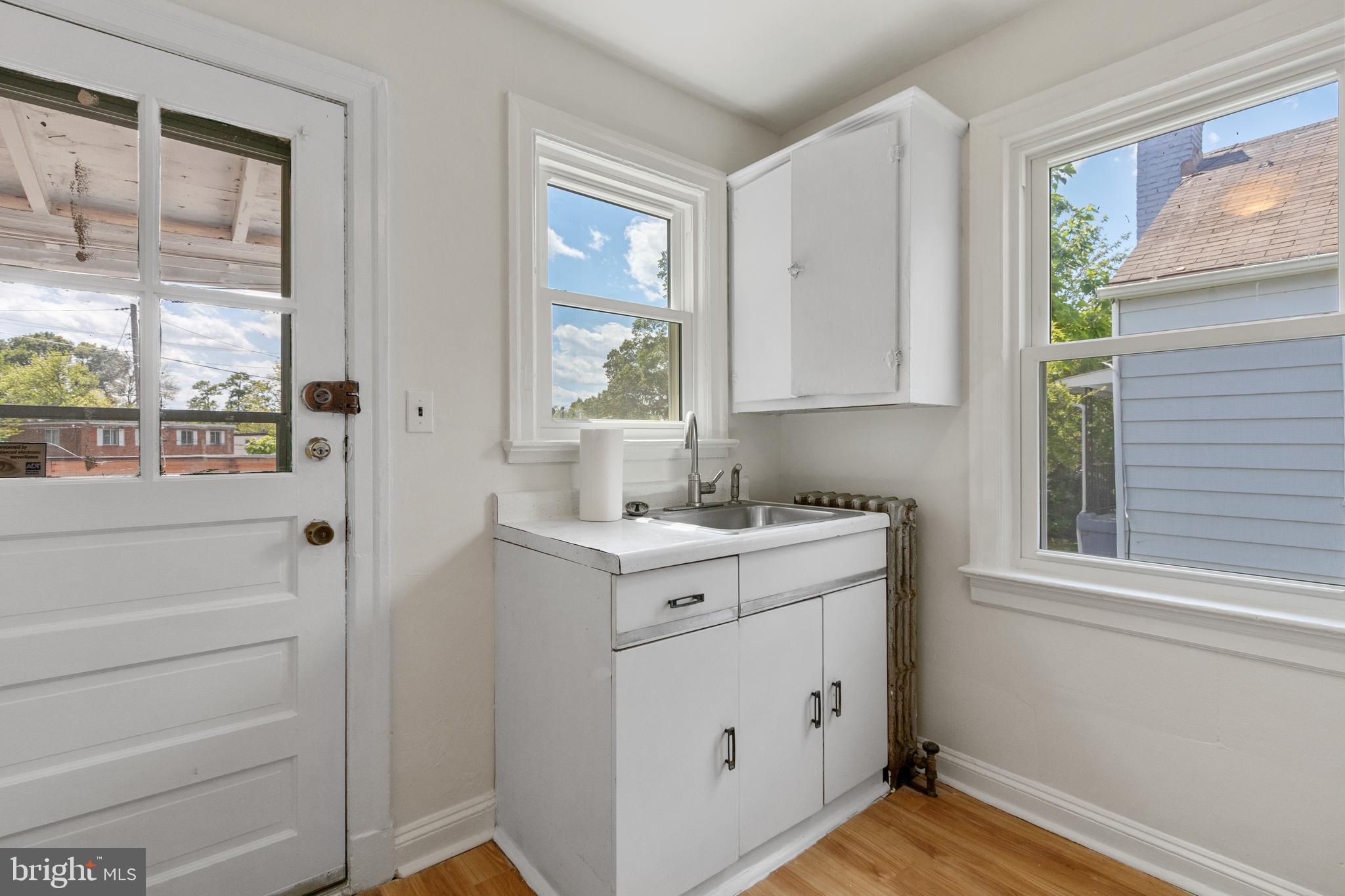 5515 Jay Street Northeast Washington, DC 20019 - Photo 11 of 20 a view of cabinets a sink and a window in a bathroom