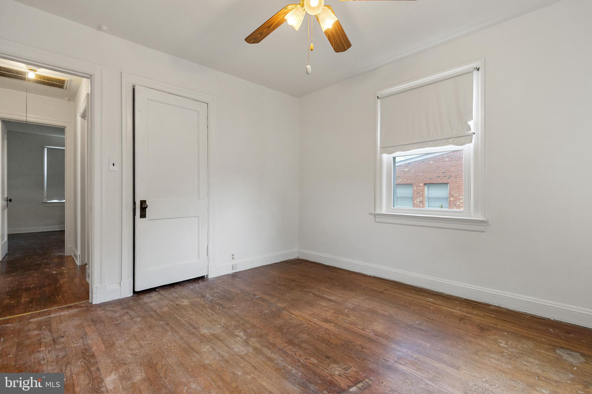 5515 Jay Street Northeast Washington, DC 20019 - Photo 5 of 20 a view of an empty room with wooden floor and a ceiling fan
