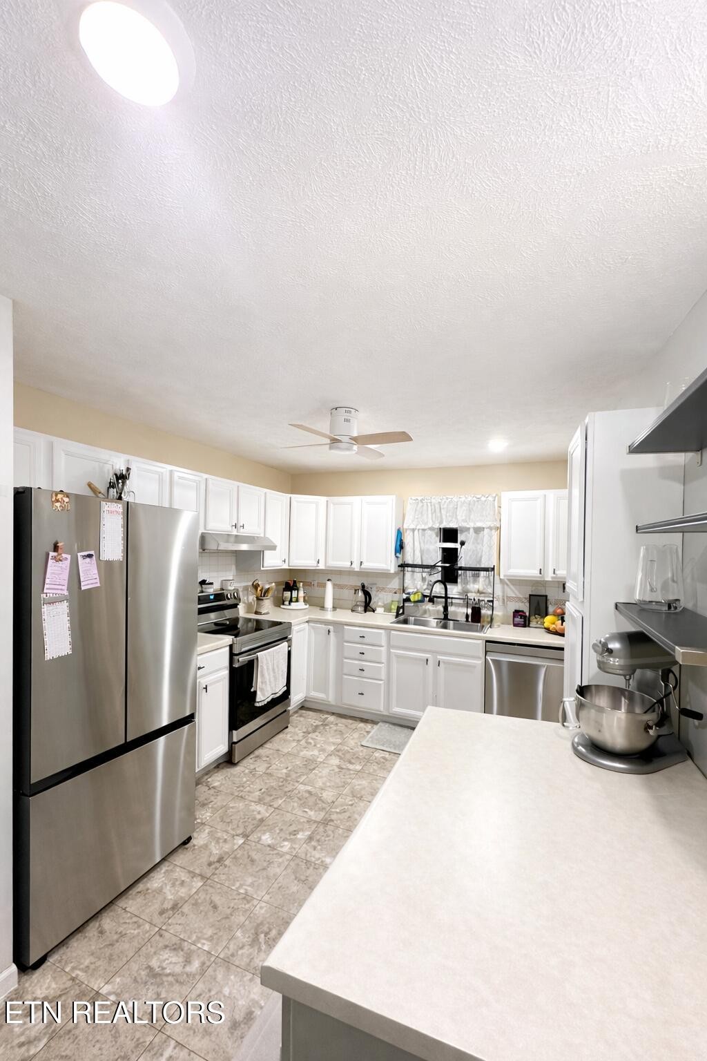15 Rena Circle Crossville, TN 38572 - Photo 10 of 14 a kitchen with stainless steel appliances a refrigerator sink and stove