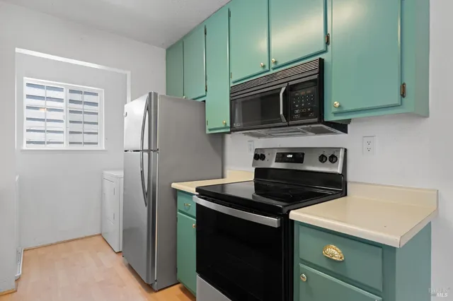 a kitchen with a stove microwave and refrigerator