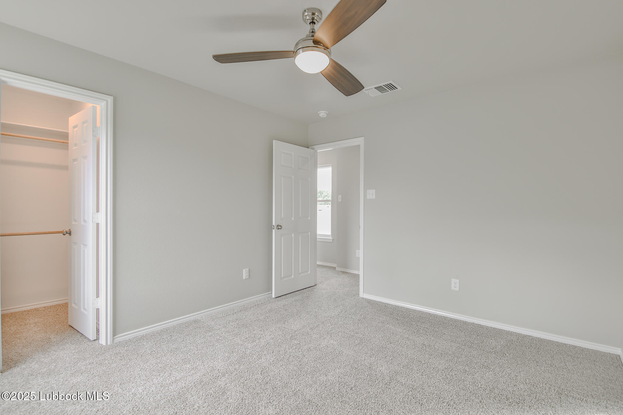 3119 74th Street Lubbock, TX 79423 - Photo 30 of 36 an empty room with a fan & a window
