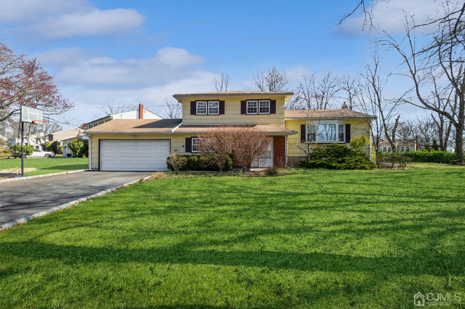2 Sherwood Road Edison, NJ 08820 - Photo 1 of 26 a front view of a house with a garden