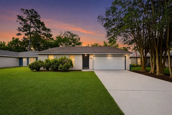 a front view of house with yard and green space
