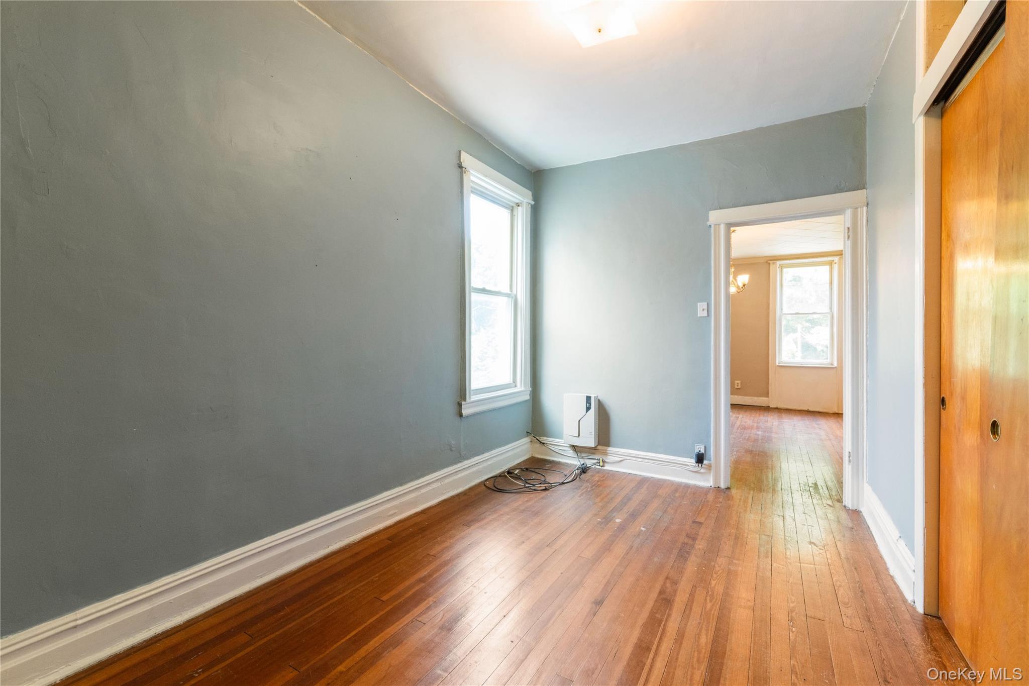 82-72 88th Place Queens, NY 11421 - Photo 16 of 26 a view of a room with wooden floor and windows