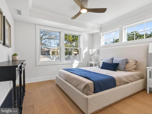 a bathroom with a toilet sink vanity and mirror