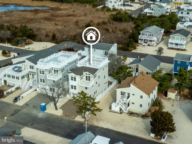 an aerial view of a residential building with an outdoor space