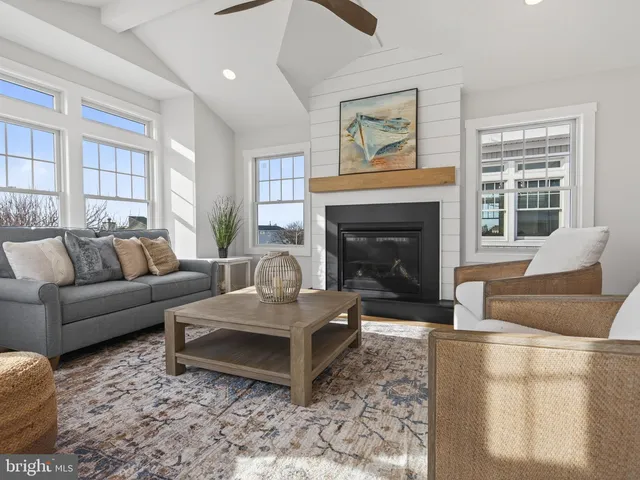 a dining room with furniture a rug and wooden floor