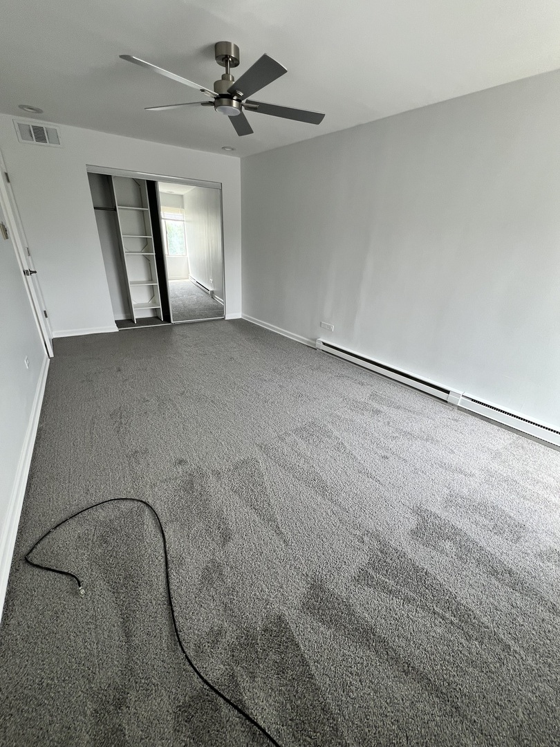 2303 Holiday Terrace, Unit 41 Lansing, IL 60438 - Photo 4 of 11 wooden floor in an empty room with a window