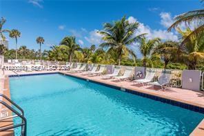 9341 Collins Avenue, Unit 604 Surfside, FL 33154 - Photo 14 of 15 a view of a swimming pool with a yard