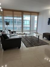 9341 Collins Avenue, Unit 604 Surfside, FL 33154 - Photo 3 of 15 a living room with furniture and a large window