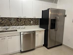 9341 Collins Avenue, Unit 604 Surfside, FL 33154 - Photo 4 of 15 a kitchen with a refrigerator and a stove