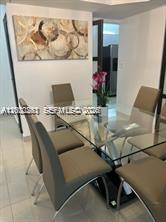9341 Collins Avenue, Unit 604 Surfside, FL 33154 - Photo 5 of 15 a room with table chairs and wooden floor