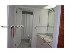 9341 Collins Avenue, Unit 604 Surfside, FL 33154 - Photo 10 of 15 a bathroom with a sink and a mirror