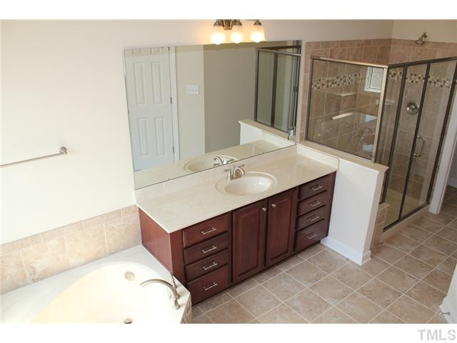2800 Bending Tree Court, Unit LT8 Raleigh, NC 27613 - Photo 12 of 25 a bathroom with a sink vanity granite and a mirror