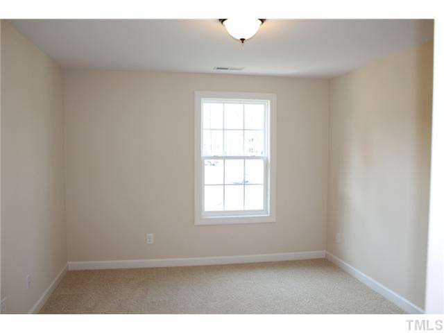 2800 Bending Tree Court, Unit LT8 Raleigh, NC 27613 - Photo 17 of 25 an empty room with wooden floor and windows