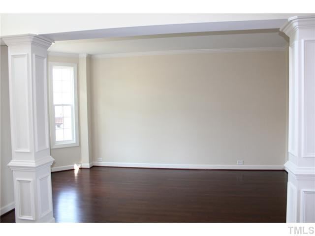 2800 Bending Tree Court, Unit LT8 Raleigh, NC 27613 - Photo 3 of 25 a view of an empty room with wooden floor and a window
