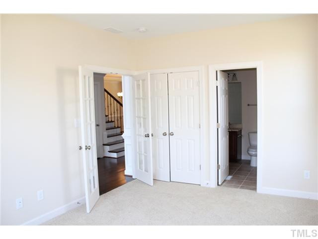2800 Bending Tree Court, Unit LT8 Raleigh, NC 27613 - Photo 8 of 25 a view of an empty room with stairs and wooden floor