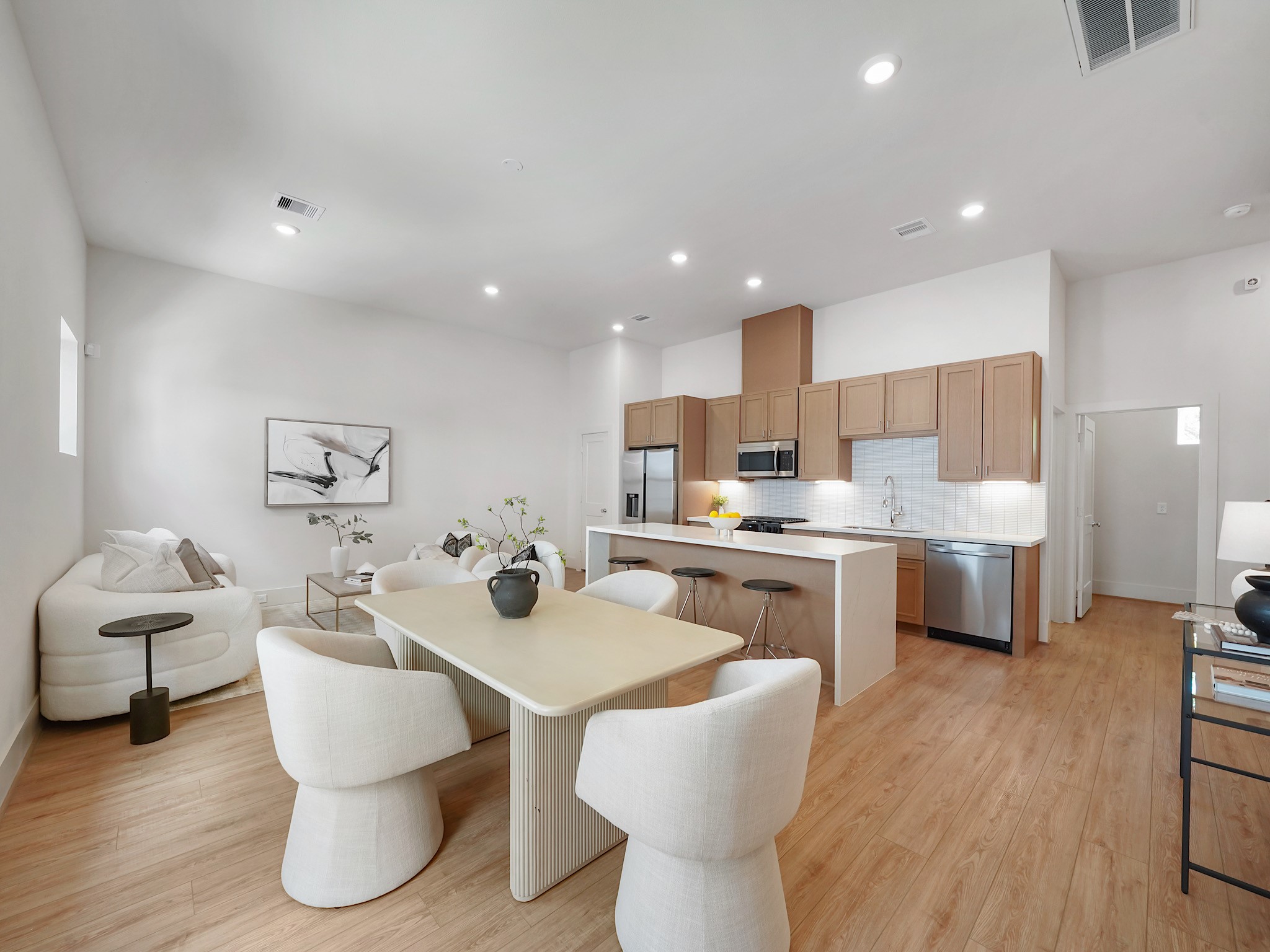 861 Rachel Street, Unit E Houston, TX 77091 - Photo 2 of 29 Experience contemporary elegance in this open-concept living space, featuring a sleek kitchen with stainless steel appliances and abundant cabinetry.