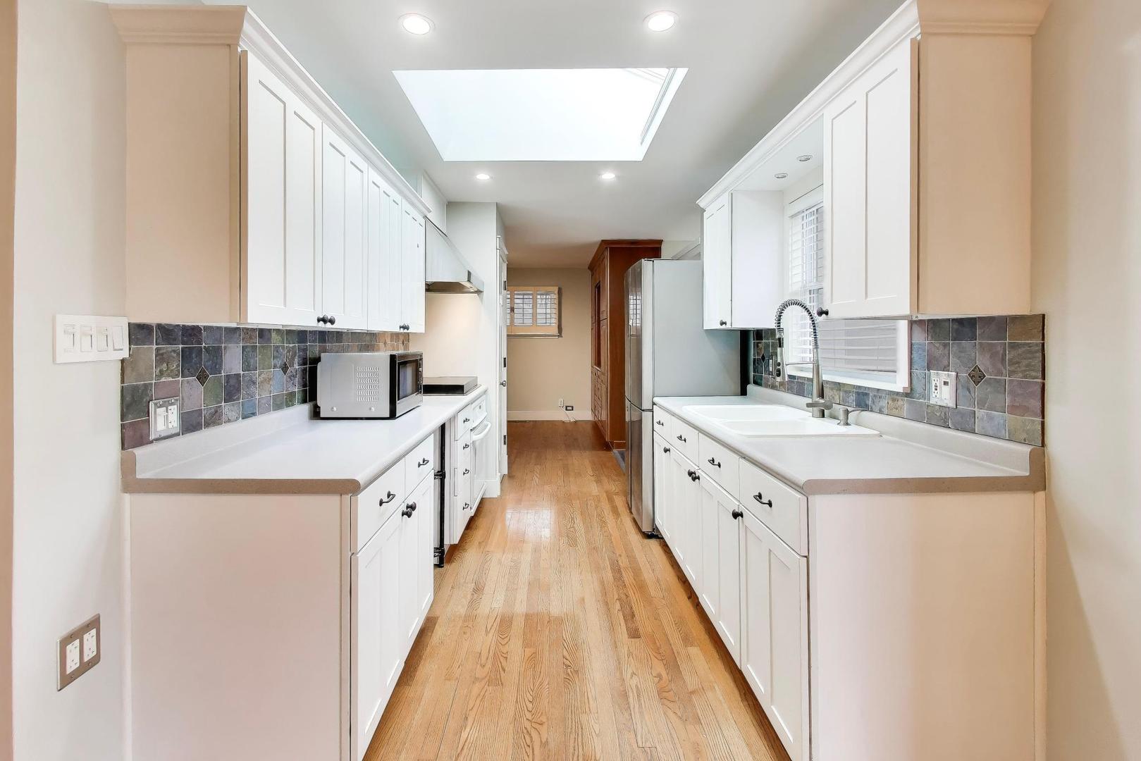 7 Alton Road Prospect Heights, IL 60070 - Photo 11 of 44 a view of a kitchen with kitchen island a sink a counter top space and stainless steel appliances