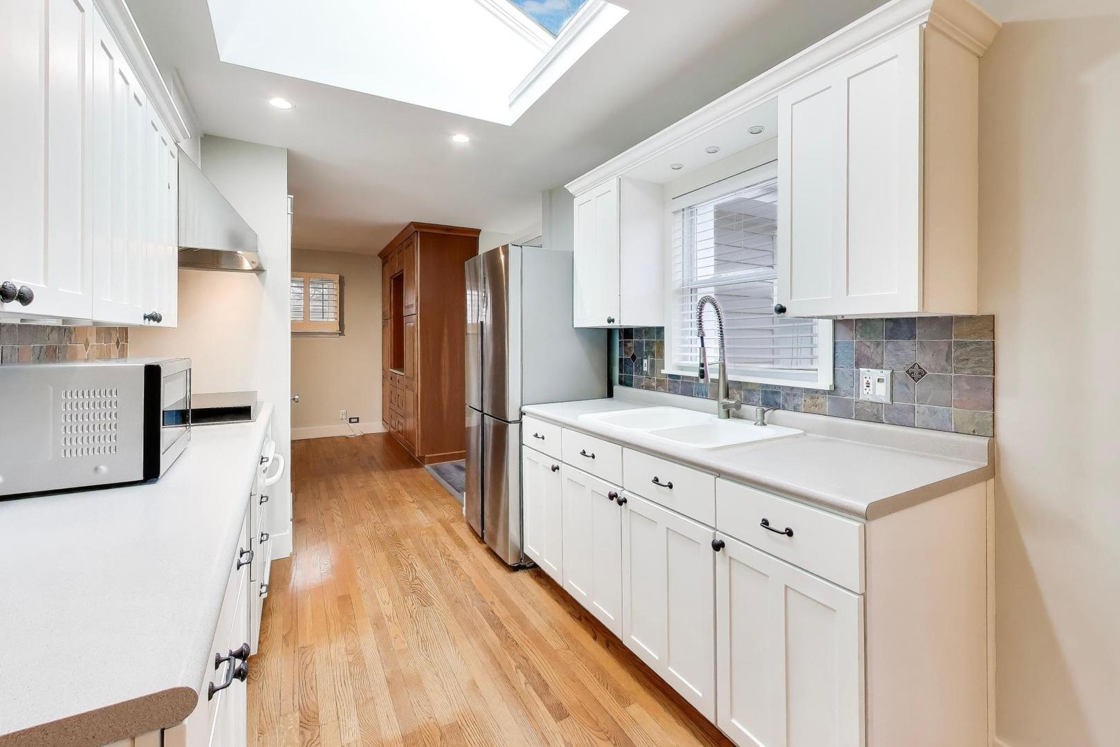 7 Alton Road Prospect Heights, IL 60070 - Photo 12 of 44 a kitchen with stainless steel appliances sink stove refrigerator and cabinets